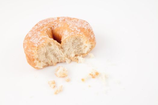 Doughnut with crumbs against white background