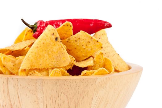 Pepper upon a bowl full of crisps against white background