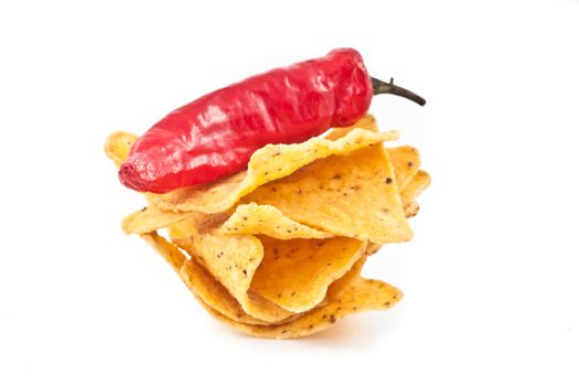 Pepper upon a small stack of crisps against white background