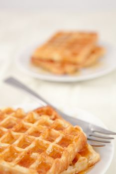 Two plateful with waffles on a table