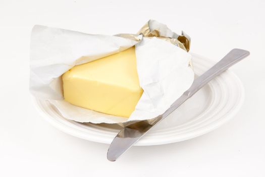 Butter on a saucer against white background