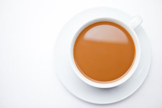 Cup of coffee with milk against white background
