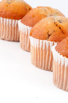 Close up of four muffins against a white background