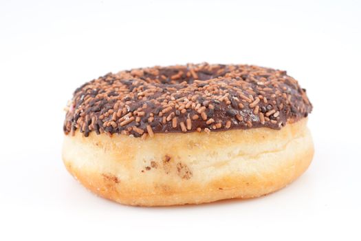 Chocolate doughnut with icing sugar against a white background