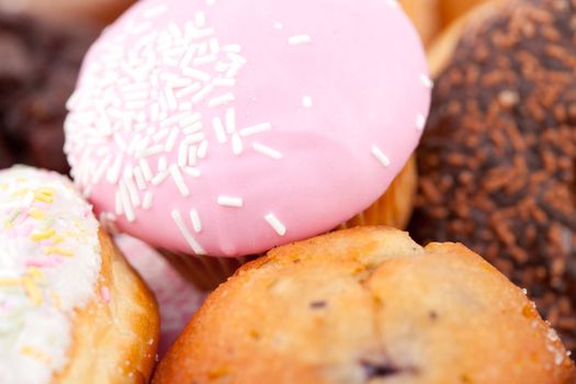 Close up on cakes with icing sugar against a white background