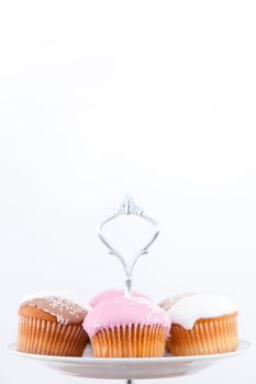 Small muffins with icing sugar against a white background