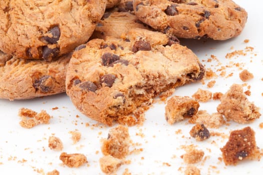 Close up of many cookies piled up together against a white background