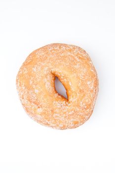 Extreme close up of a doughnut with icing sugar against a white background