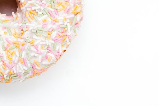 Close up of a doughnut with icing sugar against a white background