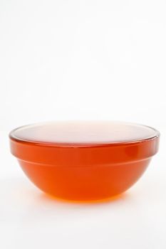 Honey full bowl against a white background