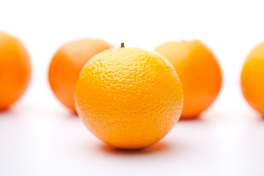 Five oranges against white background