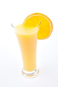 Full glass of orange juice with orange slice against white background