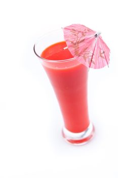 Cocktail umbrella in a berries juice against white background