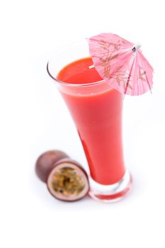 Passion fruit near a glass against white background