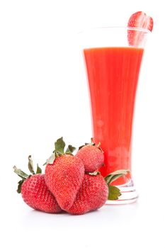 Strawberries in front of a full glass against white background