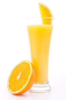 Half of am orange near a glass of orange juice against white background