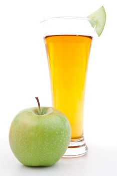 Apple near a glass of apple juice against white background