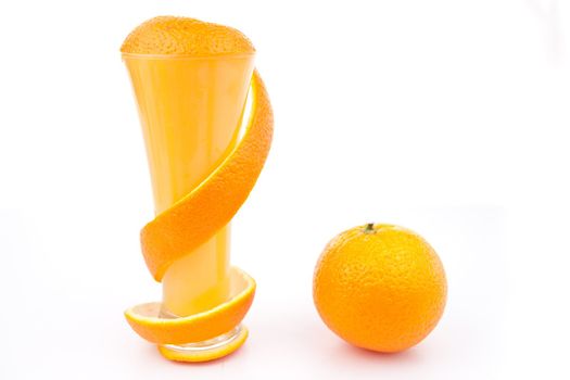 Orange peel surrounding a glass against white background