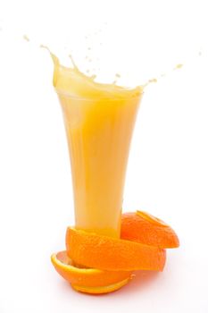 orange peel surrounded around a overflowing glass  against white background