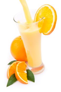 Orange juice splashing in a glass against a white background