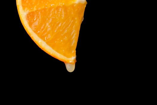Slice of orange against a black background