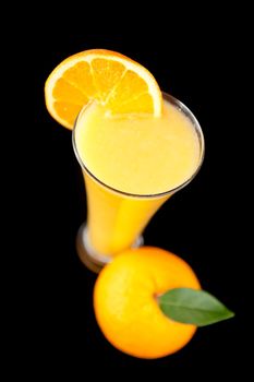 Orange fruit liquid against a black background