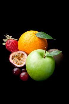 Different fruits against a black background