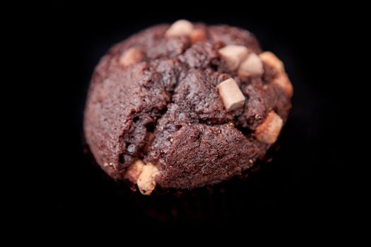 Black cookie against a black background