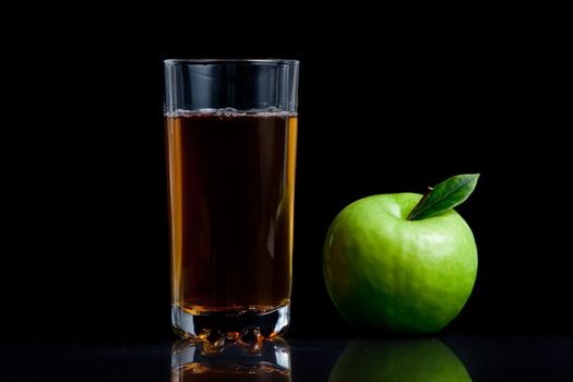 Fresh apple juice against a black background