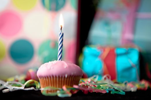 Birthday cup cake on a black table