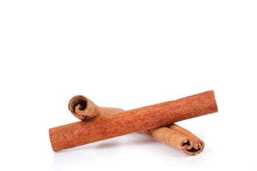 Cinnamon sticks laid out together against a white background