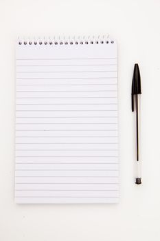Notepad  with black pen sheet  against a white background