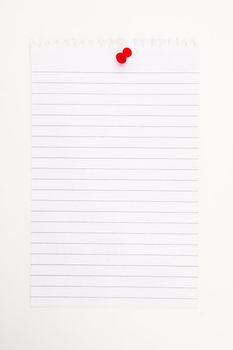 Blank page with red thumbtack against a white background