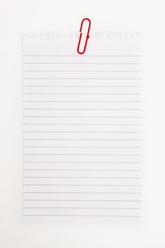 Blank page with red paperclip  against a white background