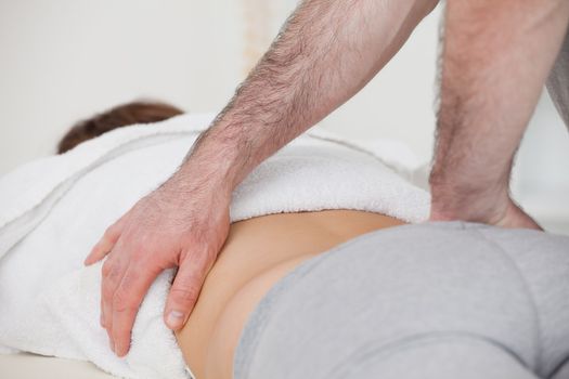 Close-up of a physiotherapist massaging a back in a physio room