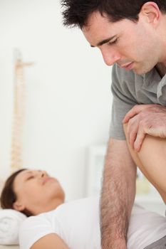 Patient being stretched by a physiotherapist in a room