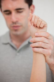 Close-up of a hand being stretched in a room