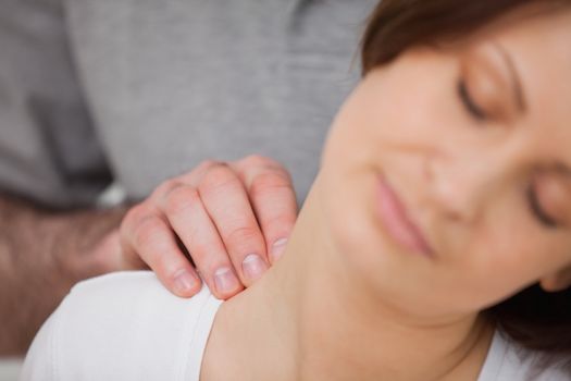 Close-up of a woman being massaged by a physiotherapist in a room