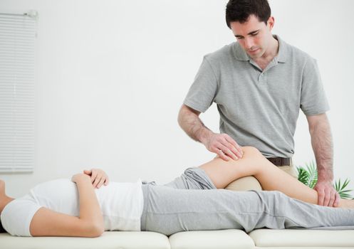 Woman lying on her back while being massaged in a room