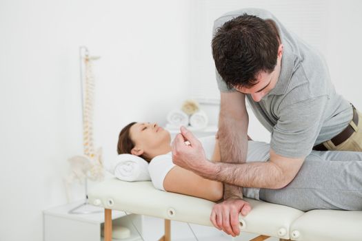 Physiotherapist massaging the pelvis of a woman in a medical room