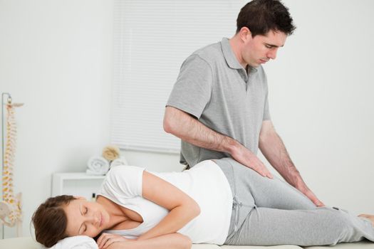 Doctor looking at the thigh of his patient in his office