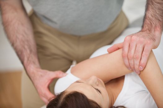 Osteopath making a joint mobilisation in his medical office
