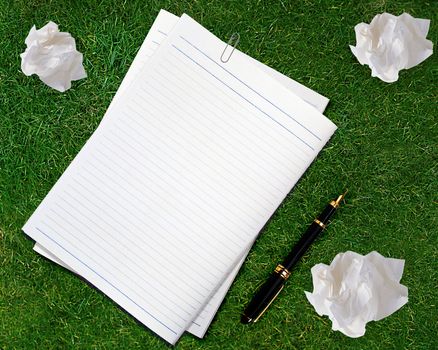 Blank white paper with pen and crumpled paper.