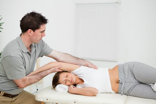 Peaceful woman being stretched in a medical room