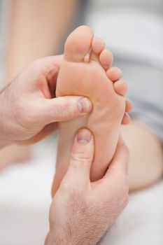 Reflexology massage being made in a room