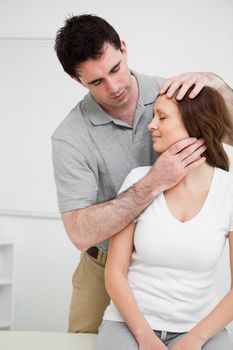 Osteopath insuring central alignment of spine in a medical room