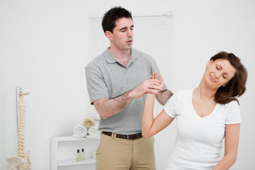 Peaceful woman being manipulated by a doctor in a medical room