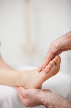 Doctor offering a foot massage in a medical room