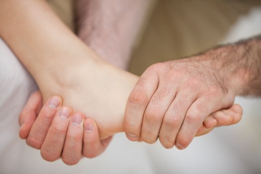 Foot being held by a practitioner indoors