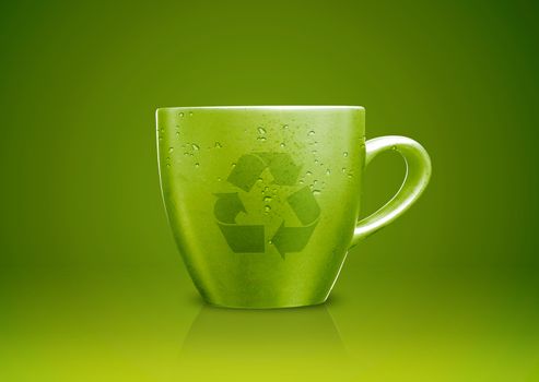 Green tea mug or cup with recycle sign on it, environmental conceptual image.